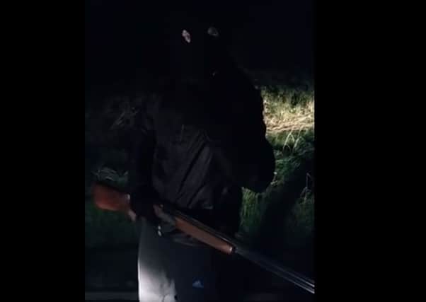 A masked man with a shotgun, apparently from the 'Banbridge Crew'