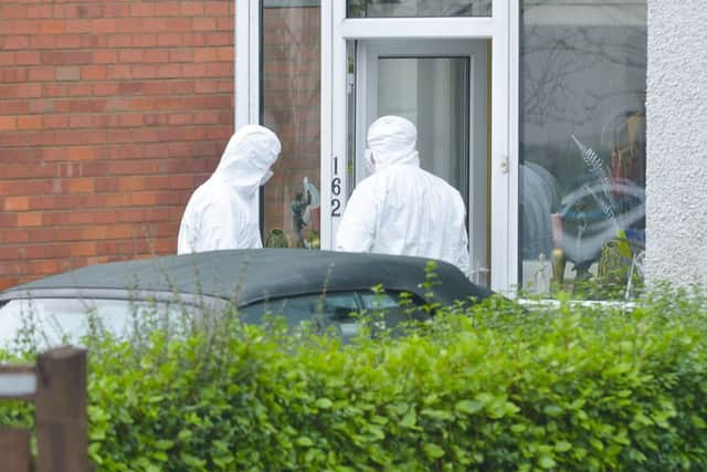 Police and forensic officers on the scene of Eddie Girvan's murder in January