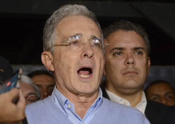 Opposition Senator and former President  Alvaro Uribe - who opposed the deal - reads a statement at his house in Rionegro, Colombia on Sunday. (AP Photo/Luis Benavides)