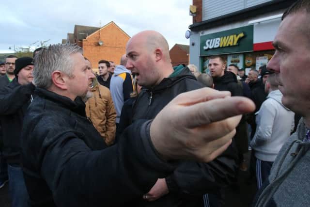 Father Gary Donegan is confronted by GARC member Dee Fennell.