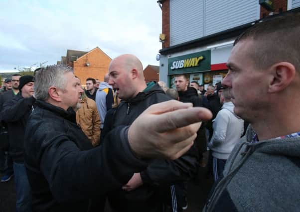 File photo dated 01/10/16 of Damien "Dee" Fennell (centre), a spokesman for the Greater Ardoyne Residents' Collective (GARC), arguing with local priest Father Gary Donegan (left) after an Orange Order parade passed along the Crumlin Road adjacent to the nationalist Ardoyne district in north Belfast