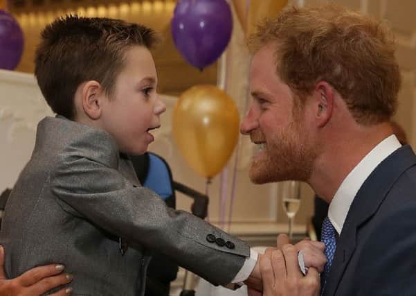 Prince Harry (right) reacts as he greets Inspirational Child Award Winner Ollie Carroll, as he attends the WellChild Awards in London:  Daniel Leal-Olivas
/PA Wire
