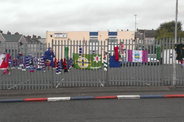 Floral tributes, flags and band uniforms on the railings outside Larne Rangers Supporters Club in tribute to Ryan Baird. INLT-40-716-con