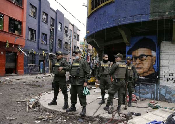 Police officers stand in the area known as El Bronx in downtown Bogota, Colombia