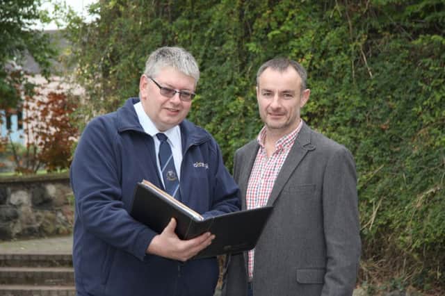 Holstein NI secretary John Martin, and vice chairman Tommy Henry, look over the entry for next week's autumn bull show and sale at Kilrea Mart.