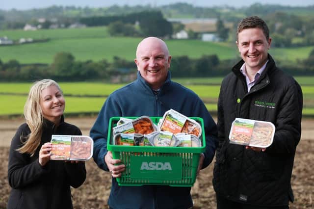 Asda regional buying manager Brian Conway pictured centre with Mash Direct head of marketing Clare Forster and sales director Lance Hamilton