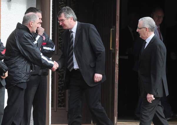Tom Elliott (centre) shakes hands with Mickey Harte and other GAA members at the funeral mass for murdered police officer Ronan Kerr in 2011. Also pictured is Danny Kennedy MLA (right)