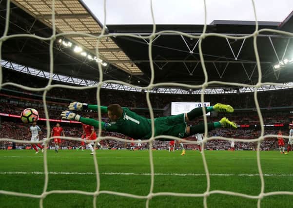 England's Daniel Sturridge scores his side's first goal as Malta's Andrew Hogg dives in vain.