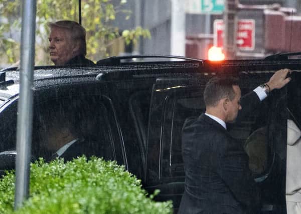 Republican presidential candidate Donald Trump, upper left, leaves Trump Tower in New York Sunday, Oct. 9, 2016. (AP Photo/Craig Ruttle)