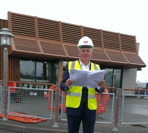 McDonald's franchisee John McCollum checks over the plans for the new restaurant at The Outlet, Banbridge.