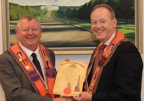 Drew Nelson presents the lodge warrant to Worshipful Master Bro William Humphrey MLA at the inaugural meeting of Stormont LOL