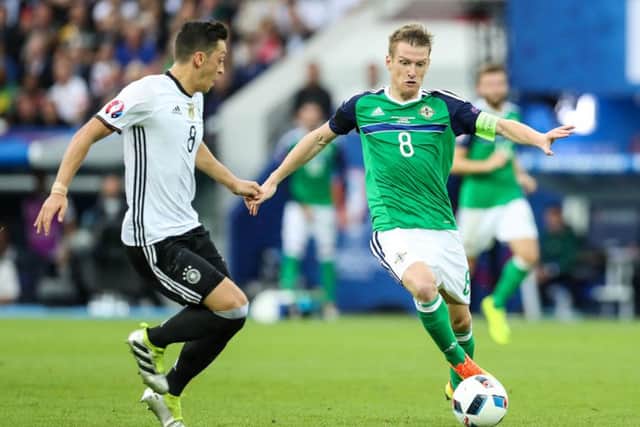 Northern Ireland's Steven Davis with Germany's Mesut Ozil
 during the European Championships in France earlier this year