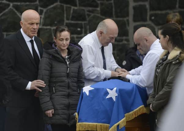 PACEMAKER BELFAST 04/11/2015 Brenda McGlinchy is comforted by former IRA bomber Sean McGlinchey during the funeral of leading Republican Declan McGlinchey in his home town of Bellaghy. Pic by Pacemaker