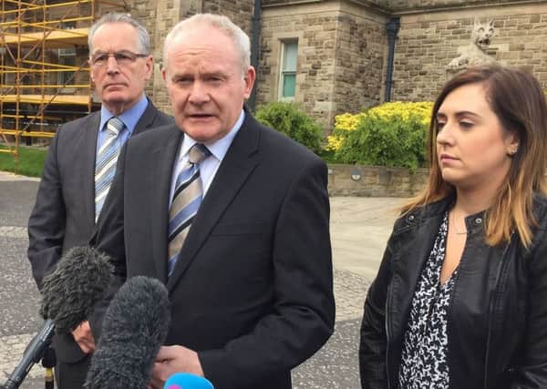 Martin McGuinness (centre) speaking outside Stormont Castle near Belfast with Sinn Fein colleagues Gerry Kelly and Megan Fearon.