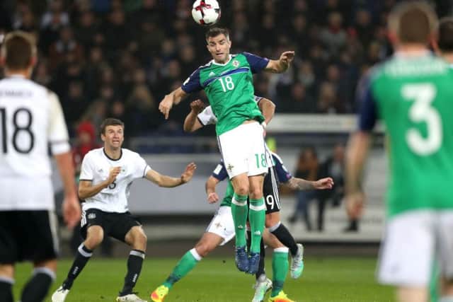 Germany's Thomas Muller with Northern Ireland's Aaron Hughes