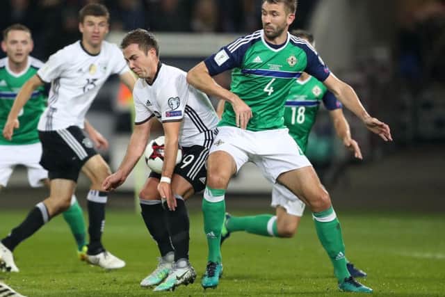 Germany's Mario Gotze with Northern Ireland's Gareth McAuley