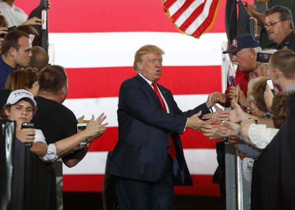 Republican presidential candidate Donald Trump arrives to speak at a campaign rally, Wednesday, Oct. 12, 2016, in Ocala, Fla. (AP Photo/ Evan Vucci)