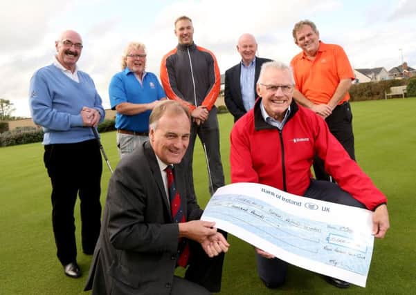 Captain of Royal Portrush Golf Club, Michael Taylor presents a cheque for Â£10,000 to Ian Crowe, Chairman of the Air Ambulance NI as Liam Beckett, Albert Kirk, Stephen Ferris, Mervyn Whyte and Adrian Logan look on.  Picture by Stephen Davison/Pacemaker Belfast INCT 42-723-CON
