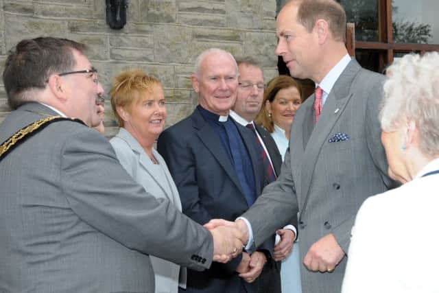 Cllr John Scott, Mayor of Antrim and Newtownabbey, greets Prince Edward on his arrival at Ballyclare High School. INNT 42-202-AM