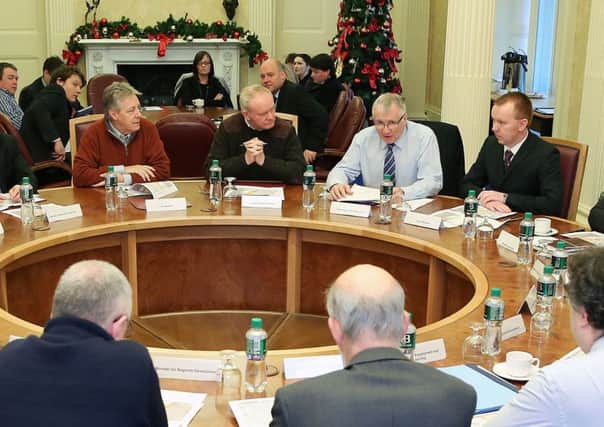Sir Malcolm McKibbin is pictured to Martin McGuinness's left at this Executive meeting in 2014