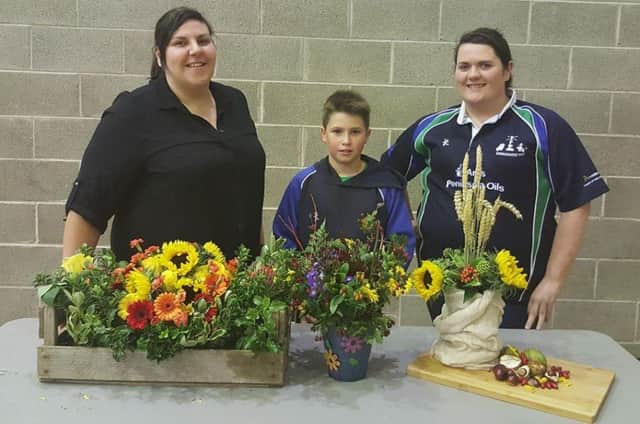 Members from Donaghadee YFC showing off their floral displays at the YFCU Floral Art Heats