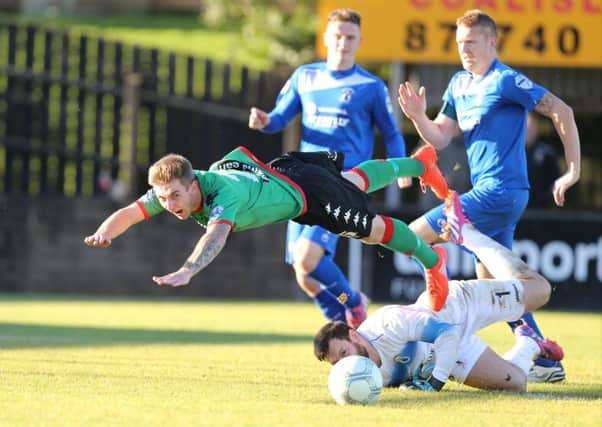 k
Jonathan Smith of Glentoran is awarded a penalty after he was takled by the Dungannon goalkeeper Andy Colman