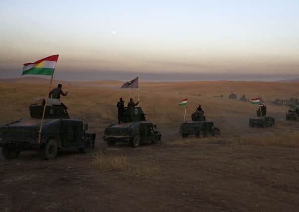 A Peshmerga convoy  part of the pro-government coalition  drives towards a frontline in Khazer, about 19 miles east of Mosul on Monday