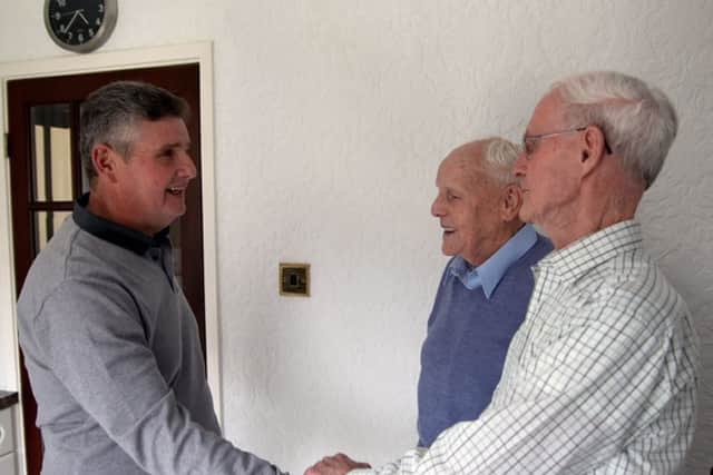Aberfan survivor Phil Thomas (left) meeting two of his rescuers - Len Haggett (right) and Dave Thomas