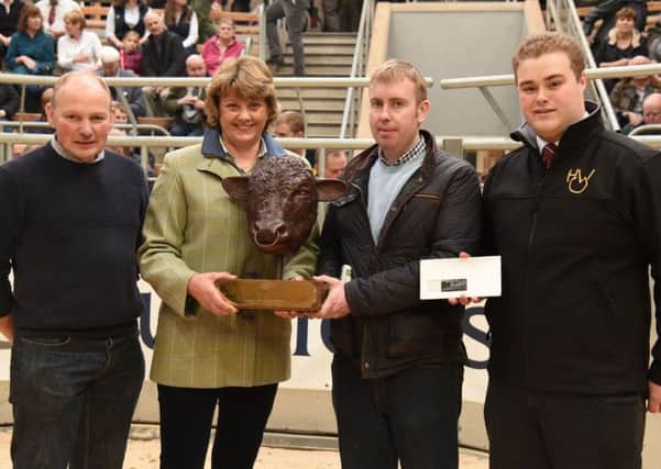 Uppermills James Porter receives the Mohmar trophy at Stirling bull sales this week from Beef Shorthorn Societys vice president, Sally Horrell with left, Uppermill stockman, Ian Rea and Highland Wagyus John McCulloch.