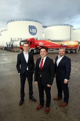 Danske Banks Ciaran McLaughlin is pictured with LCC directors Dan Loughran and Michael O Loughran at the companys oil terminal at Foyle Port at Lisahally in Co Londonderry
