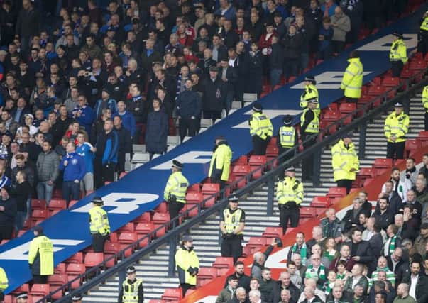 A police line divide the fans during the Betfred Cup, Semi Final match at Hampden Park, Glasgow. PRESS ASSOCIATION Photo. Picture date: Sunday October 23, 2016. See PA story SOCCER Rangers. Photo credit should read: Jeff Holmes/PA Wire. EDITORIAL USE ONLY