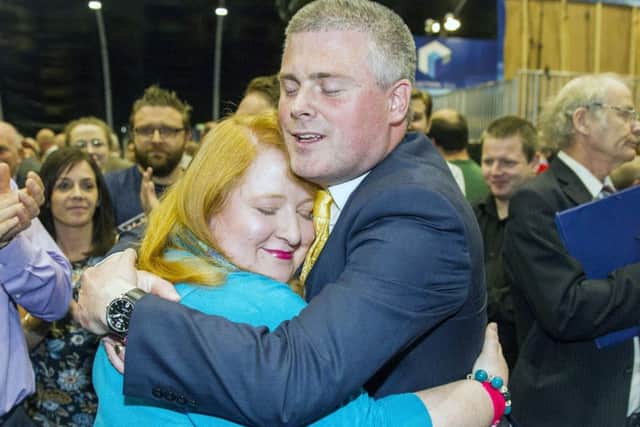 Naomi Long of the Alliance Party is congratulated by her husband Michael Long after being elected as MLA for Belfast East, May 6, 2016
