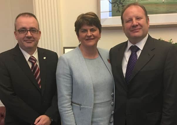 Graham Craig, right, is welcomed to the DUP by Arlene Foster and Lee Reynolds