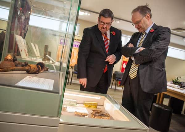 Education Minister Peter Weir undertakes a guided tour of the Museum of Orange Heritage, Belfast, with curator Dr Jonathan Mattison.