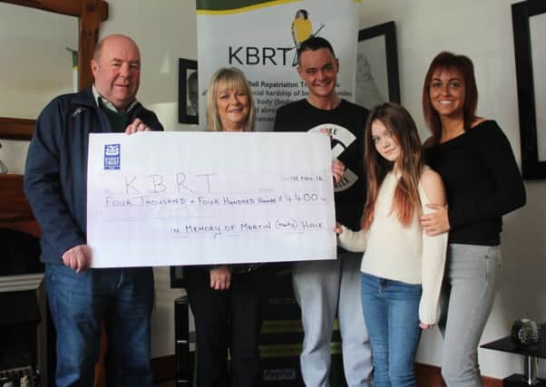 Colin Bell of the Kevin Bell Repatriation Trust receives a cheque for Â£4,400 from Martin Hale's mother Teresa Temple, his brother Daniel Temple, sister Rebecca Temple and his daughter Cora McGreevy.