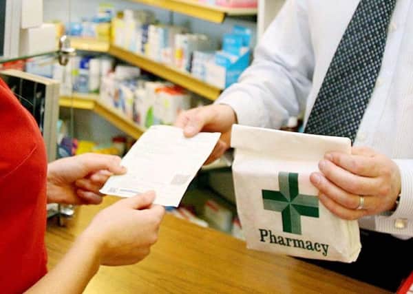 A woman receiving her prescription medicine from a pharmacist in Northern Ireland.