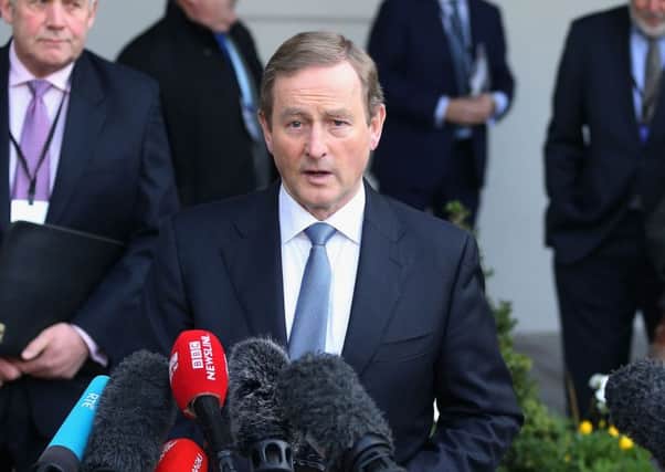 Enda Kenny talks to the media before the start of the conference in Dublin