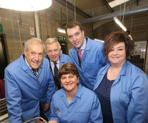 First Minster Arlene Foster takes the task of soldering a circuit board in her stride. Looking on are (l-r) Councillor Uel Mackin, Chairman of the council's Development Committee; Mayor Brian Bloomfield MBE;  Terry Simpson, owner and Managing Director of Power Action and Arcatech; and Power Action employee Margaret Stewart.
