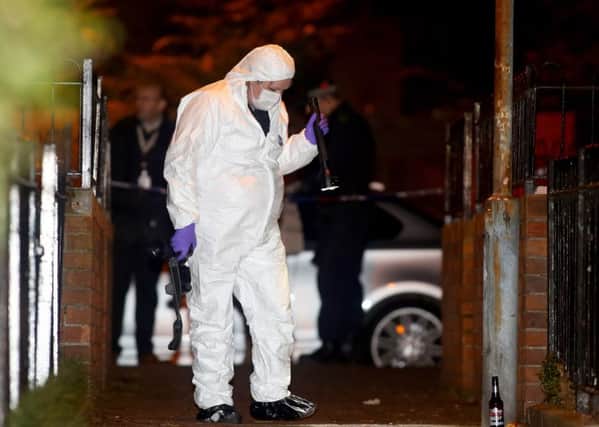 Police at the scene of a shooting in the Springview Walk area of west Belfast on Sunday night.