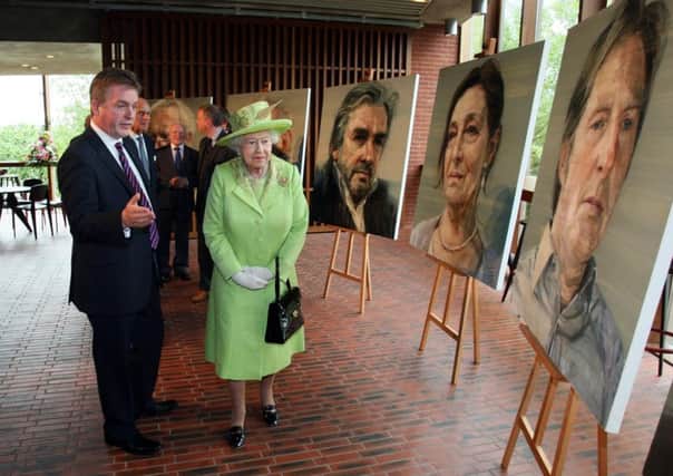 Lyric Theatre chairman Mark Carruthers showing the Queen some of Colin Davidsons paintings in 2012