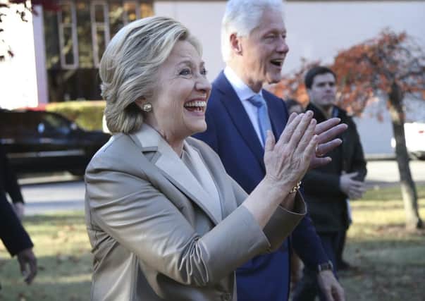 Democratic presidential candidate Hillary Clinton, and her husband former President Bill Clinton, greet supporters after voting in Chappaqua, N.Y., Tuesday, Nov. 8