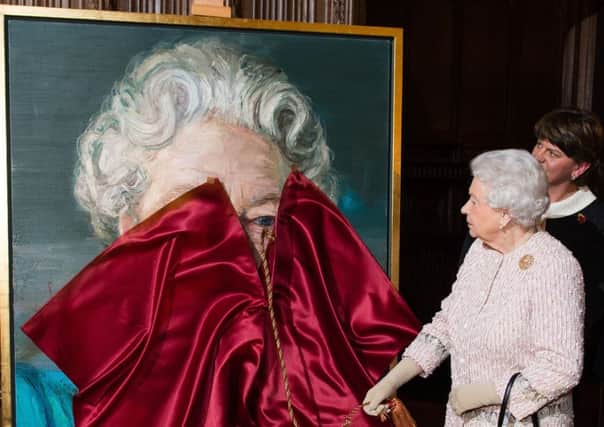 Queen Elizabeth II unveils a portrait of herself by artist Colin Davidson. Photo credit should read: Jeff Spicer/PA Wire