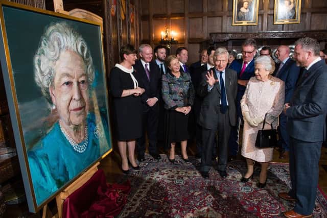 (left to right) Arlene Foster, Martin McGuinness, Frances Fitzgerald, James Brokenshire, Dr. Christopher Moran, Queen Elizabeth II and  artist Colin Davidson at a Co-operation Ireland reception at Crosby Hall in London. Photo credit should read: Jeff Spicer/PA Wire
