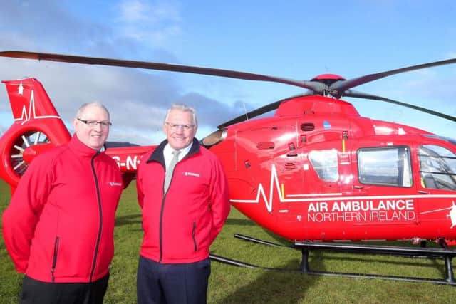One of the two helicopters which will deliver Northern Ireland's first ever Helicopter Emergency Medical Service. Pictured with the Airbus is Air Ambulance Northern Ireland chairman Ian Crowe and trustee Ray Foran. Picture by Jonathan Porter/Press Eye