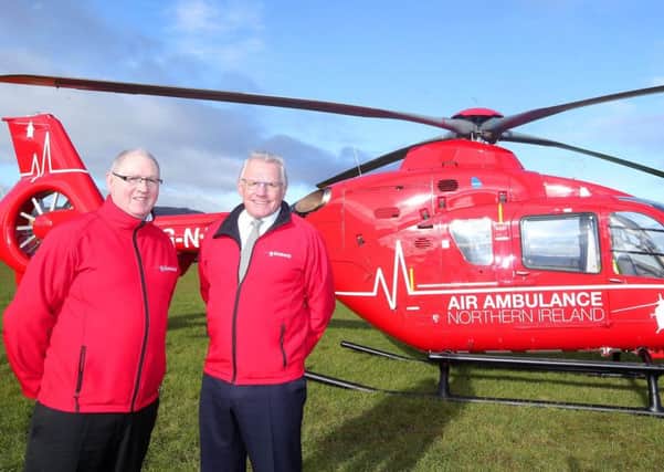 One of the two helicopters which will deliver Northern Ireland's first ever Helicopter Emergency Medical Service. Pictured with the Airbus is Air Ambulance Northern Ireland chairman Ian Crowe and trustee Ray Foran.  Picture by Jonathan Porter/Press Eye