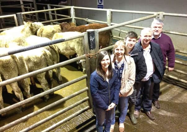 The McCarragher family, who are supporting the annual Christmas Show & Sale at Markethill livestock mart, in memory of Lesley-Ann, discussing the event with Hampton Hewitt.
