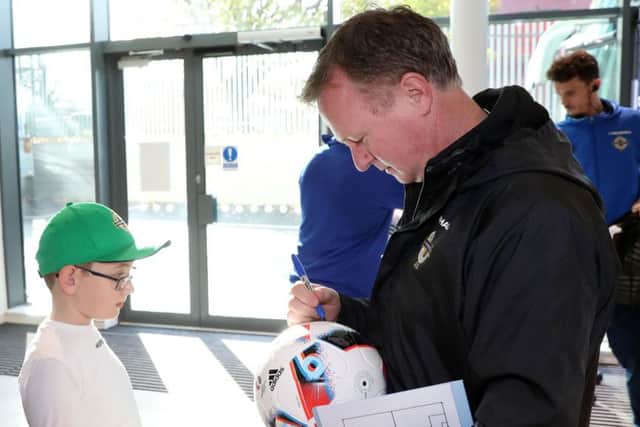 Michael O'Neill signs autographs for Vauxhall competition winners at the National Stadium ahead of Friday nights World Cup Qualifier against Azerbaijan at the National Stadium at Windsor Park. Pic: Presseye