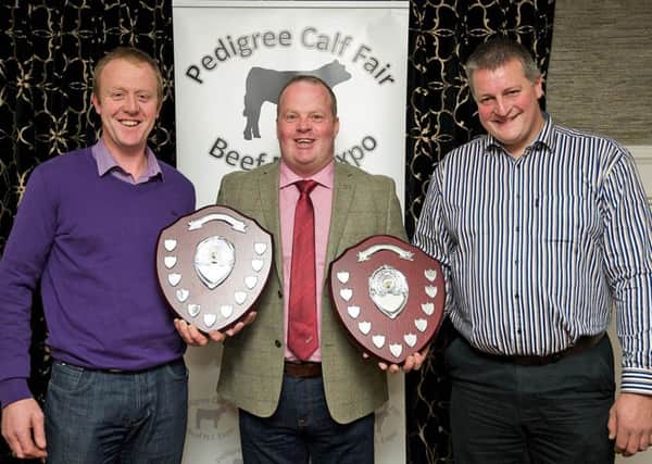 NI Blonde Club secretary Brian McGartland, and vice-chairman Roger Johnston, present two shields to Pedigree Calf Fair chairman David Connolly.