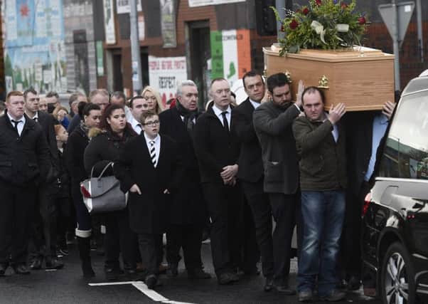 Mourners at the funeral of James Hughes