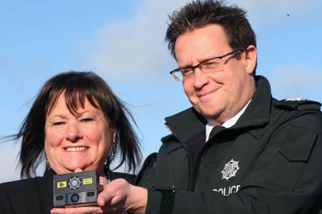 Chief Superintendent Chris Noble and chair of the Policing Board, Anne Connolly, with one of the body-worn cameras